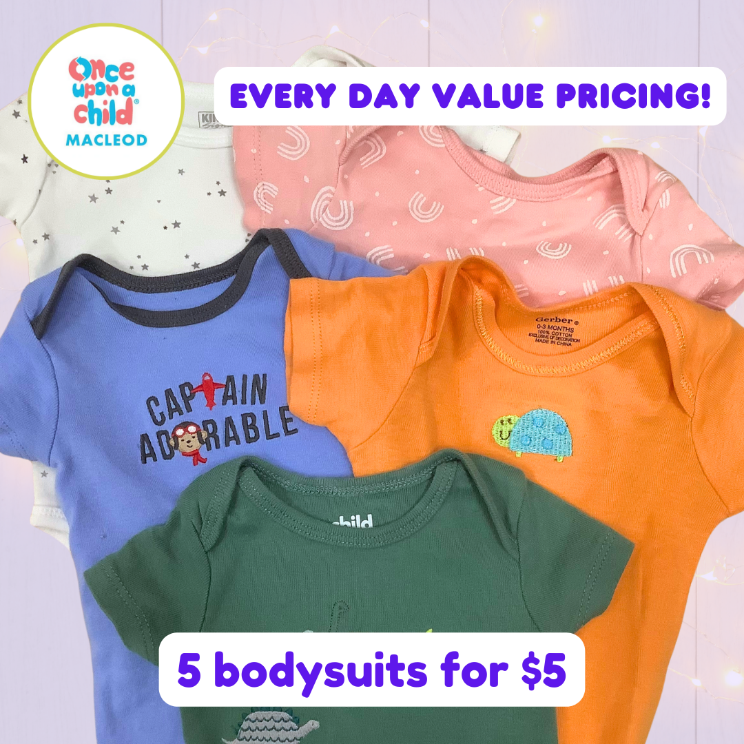 5 assorted infant bodysuits are laid on a purple background: a white bodysuit with grey stars, a pink bodysuit with white rainbows, a blue bodysuit with the words 